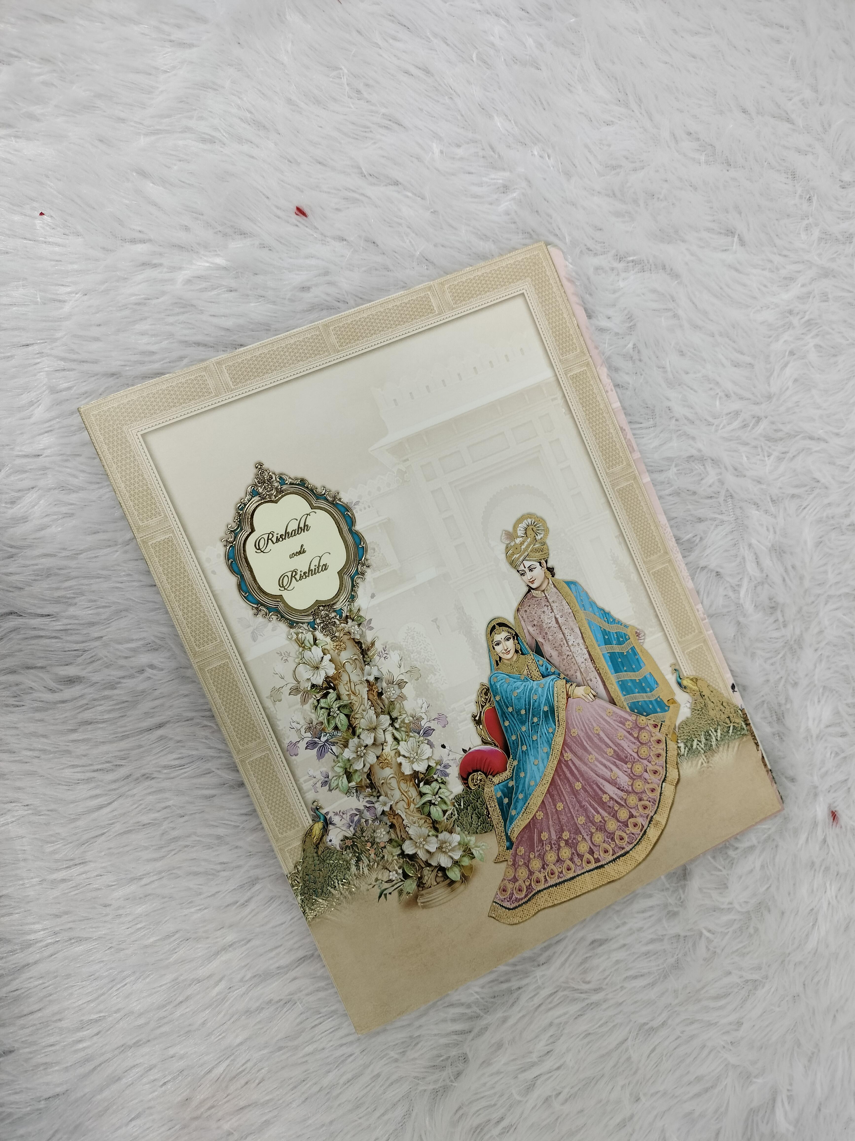 Cream Indian Wedding Invitation Card with Royal Bride Groom Illustration and Floral Motifs ("AC-515")
